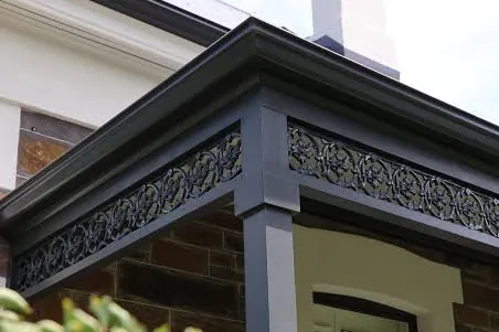 Dark grey gutter and fascia on a brick house with a decorative verandah